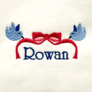 Birds holding delicate ribbon with bow